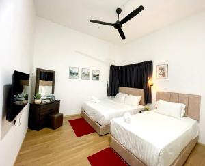 a bedroom with two beds and a ceiling fan at Skyn Heaven Penthouse in Tanah Rata +3 photos