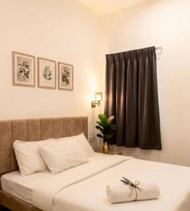 a bedroom with a bed with a black curtain at Skyn Heaven Penthouse in Tanah Rata