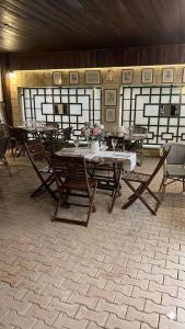 a room with tables and chairs with flowers on it at Boeme88 in Eforie Sud