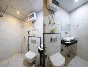 a bathroom with a toilet and a sink at Hotel Grand Loft Near IGI Airport New Delhi in Pilwa +21 photos