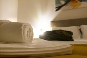 a close up of a bed with towels on it at Moby Dick Guesthouse in Atouguia da Baleia