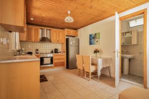 a kitchen with a table and a dining room at Villa Liana in Frikes