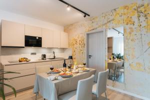 a kitchen and dining room with a table and chairs at Apartments GoldRain in Coldrano +9 photos