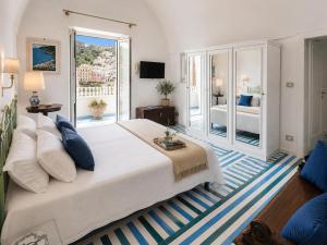 a large bedroom with a large bed and a balcony at Villa Positano with sea view ! in Positano