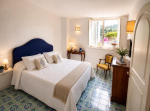 a bedroom with a large bed and a window at Villa Positano with sea view ! in Positano