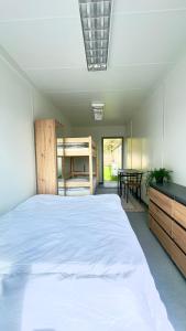 a bedroom with a large white bed and a table at Maszoperia Sun4hel Kite & Wind & Surf in Jastarnia +209 photos