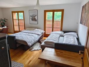 a living room with two beds and a couch at Conny's Lodge in Schruns