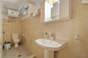 a bathroom with a sink and a toilet at Villa Liana in Frikes +31 photos