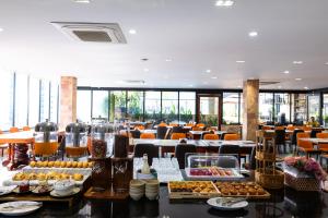 a buffet line with food on display in a restaurant at Amana Hotel Phnom Penh in Phnom Penh