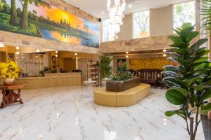 a lobby of a store with a large painting on the wall at Amana Hotel Phnom Penh in Phnom Penh