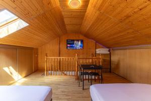 a room with a bed and a table and a tv at Semi-detached Hse in Loeches