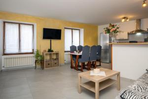 a living room with a couch and a dining room at Chez Lulu in Brézins
