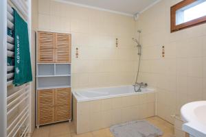 a bathroom with a bath tub and a sink at Chez Lulu in Brézins +19 photos