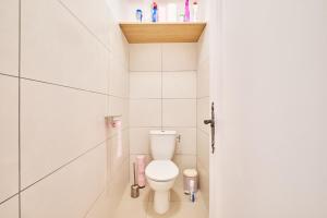 a white bathroom with a toilet in a stall at Chez Emile in Brézins +19 photos