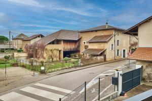 an empty street with houses and a fence at Chez Emile in Brézins