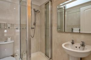 a bathroom with a shower and a toilet and a sink at Finest Retreats - Hollies Coach House in Martock +15 photos