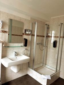 a bathroom with a sink and a shower at HOTEL SPECHT Tremonia Group - Dortmund in Dortmund