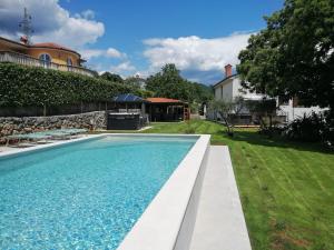 a swimming pool in the backyard of a house at Villa Riviera blue with seaview, pool, whirlpool, parking and boat excursions in Opric