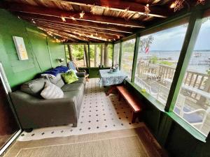 a living room with a couch and a table at BEACHSIDE ON SEBAGO LIMIT 6 villa in Standish