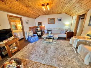 a living room with a couch and a table at BEACHSIDE ON SEBAGO LIMIT 6 villa in Standish