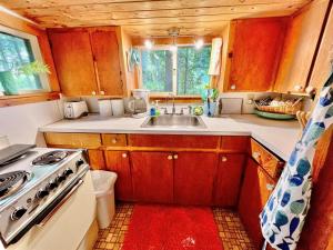 a small kitchen with a sink and a stove at BEACHSIDE ON SEBAGO LIMIT 6 villa in Standish +5 photos