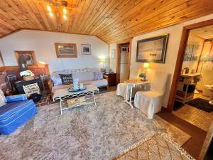 a living room with a couch and a table at BEACHSIDE ON SEBAGO LIMIT 6 villa in Standish