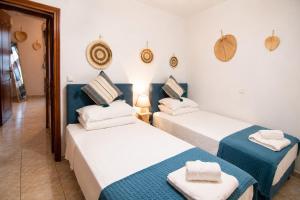 two beds in a room with blue and white at Indaba Luxury Apartments in Myrina
