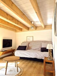 a bedroom with a bed and a table and a tv at Cozy Studio in Marck
