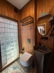 a bathroom with a sink and a toilet and a mirror at Bruno House in Almaty +14 photos