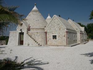 a small brick building with a tower on top at B&B Masseria Nardelli in Locorotondo