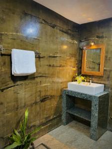 a bathroom with a sink and a mirror at LEAFORA Cottage in Galle +47 photos