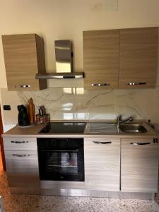 a kitchen with a sink and a stove at Dimora Civita in Castelcivita +5 photos