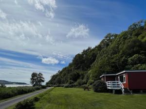 a house on the side of a road next to a mountain at Lochead Chalet 1 in Lochgilphead