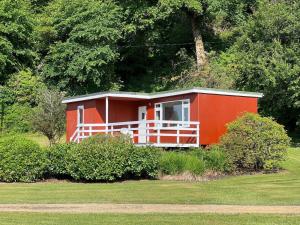 a small red house in the middle of a field at Lochead Chalet 1 in Lochgilphead +3 photos