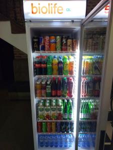 a refrigerator filled with lots of soda and sodas at Hotel Hirot in Tashkent