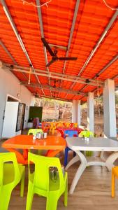 a room with tables and chairs and a ceiling at Beach and Hills Resort Diveager in Kārle