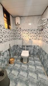 a bathroom with a white toilet in a room at Beach and Hills Resort Diveager in Kārle +19 photos