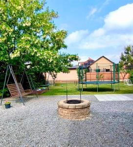 a park with a playground with a swing at GRAND HOME Apartman in Sárospatak