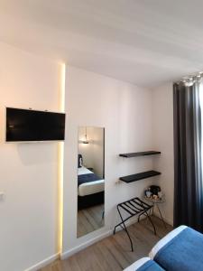 a bedroom with a mirror and a bed and a bed at Hotel El Siglo in Valencia +61 photos