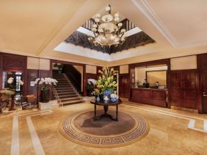 a lobby with a vase of flowers on a table at Sofitel Legend Metropole Hanoi in Hanoi +212 photos