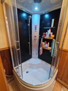 a shower with a glass door in a bathroom at Urusel Hostel in Tallinn +125 photos