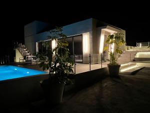 a house with a swimming pool at night at Sotogrande Polo Experience Luxury Villa in Sotogrande
