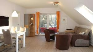 a living room with a couch and a table at Haus Eichenkrone in Bodstedt