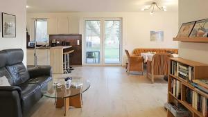 a living room with a couch and a table at Haus Eichenkrone in Bodstedt