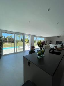 a kitchen and living room with a view of a pool at Sotogrande Polo Experience Luxury Villa in Sotogrande