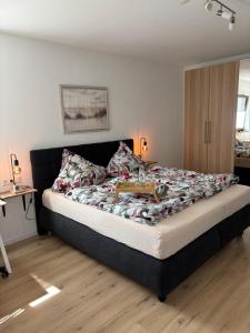 a bedroom with a bed with a box on it at Ferienwohnung Auszeit am Waldrand in Olpe