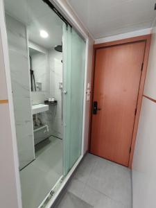 a bathroom with a glass door and a sink at Ocean Inn in Hong Kong +24 photos