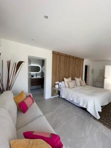 a bedroom with a large bed and a couch at Sotogrande Polo Experience Luxury Villa in Sotogrande +9 photos