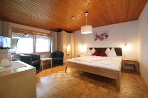 a bedroom with a bed and a desk in a room at Aparthotel Bergkristall in Brand