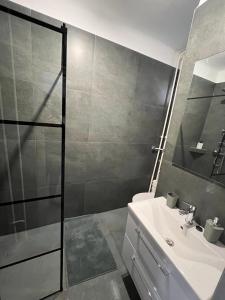 a bathroom with a toilet and a sink and a shower at Sweet Escape Pécs in Pécs +9 photos